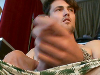 A dark-haired faggot enjoys jerking his dick off in the living room