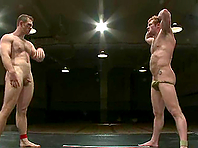 Two gay hunks rub each other's cocks during a battle on tatami